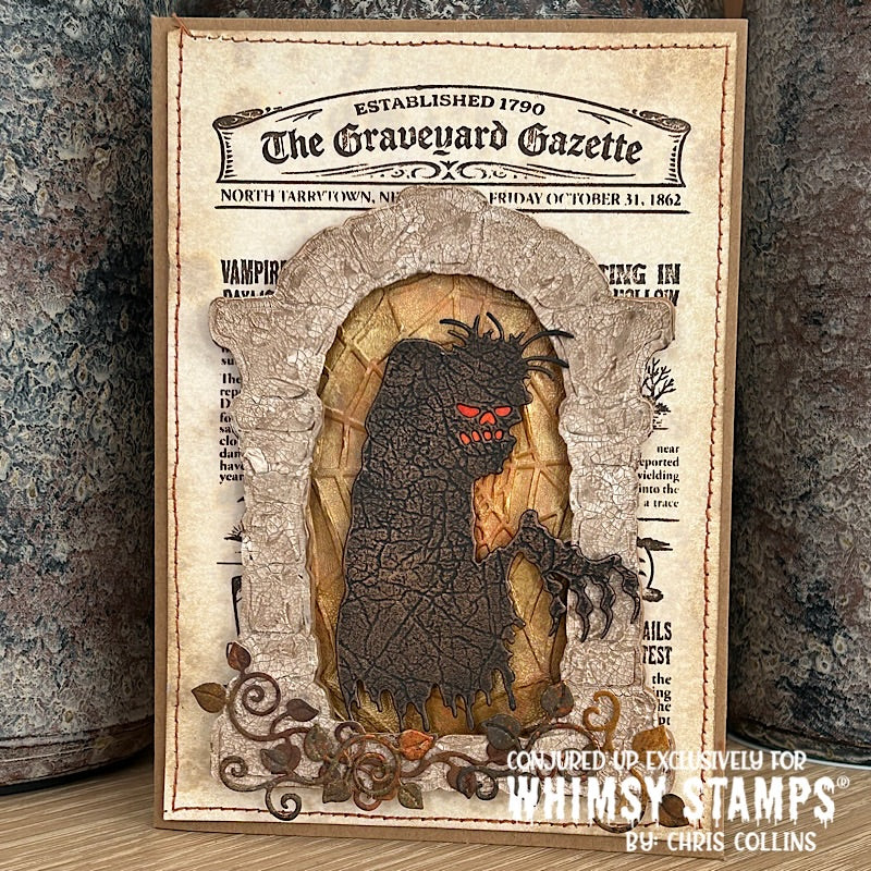A handmade Halloween card featuring a dark, textured Zombie with glowing red eyes emerging from a stone archway, styled as an antique newspaper titled 'The Graveyard Gazette'. 