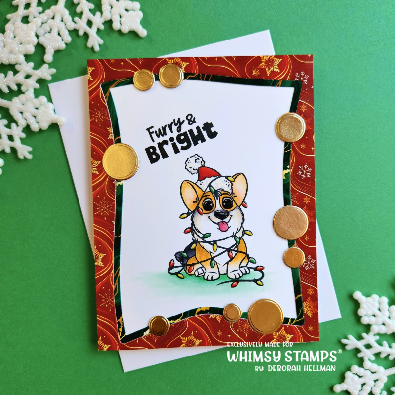 A handmade Christmas greeting card featuring a cartoon corgi wearing a Santa hat and holiday lights, layered over a red patterned paper with gold circular embellishments. 