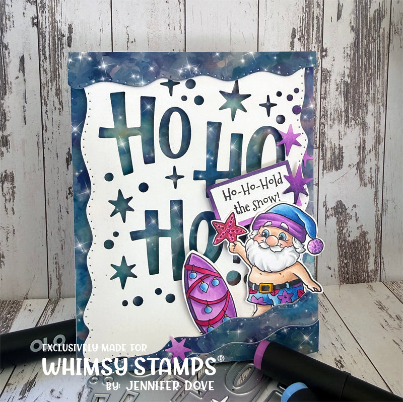A handmade greeting card featuring a whimsical Santa Claus character and the text 'Ho Ho Ho' in a snowy starry design, with the sentiment Ho Ho Hold the Snow! Santa is colored in blues and purples. 