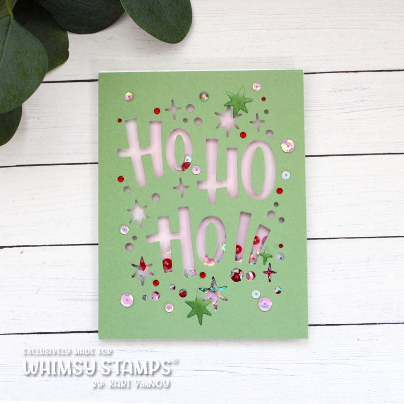 A handmade layered card featuring the words 'HO HO HO!' die cut from green paper, mounted over white paper to create a shaker card.  Embellished with colorful sequins and star-shaped die cut pieces. 
