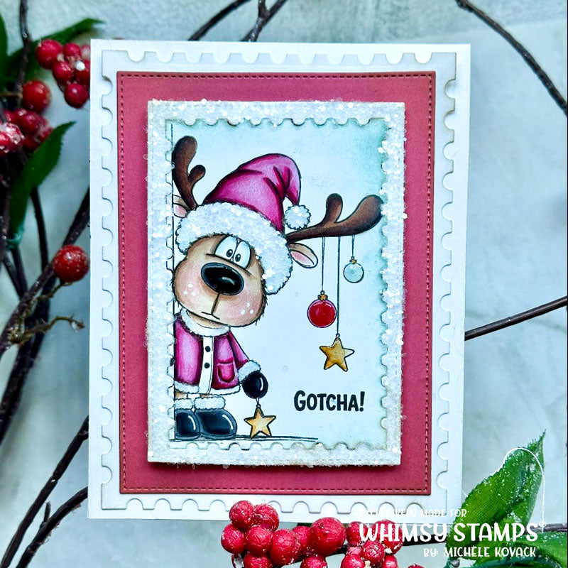 A handmade Christmas greeting card featuring a cartoon reindeer dressed as Santa with the text 'Gotcha!' and hanging ornaments.