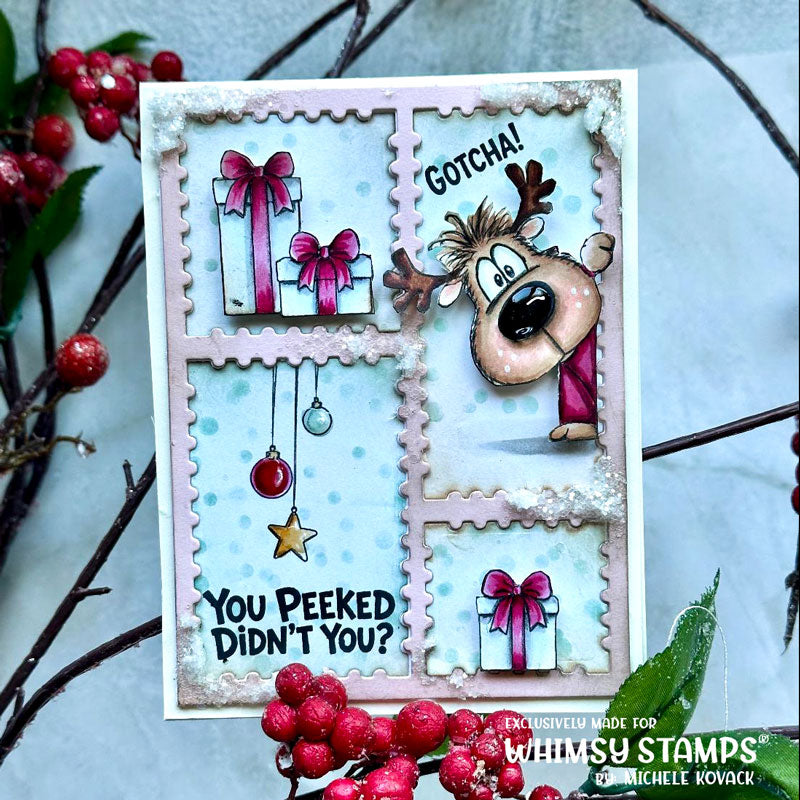 A handmade holiday greeting card with a whimsical reindeer and gift stamps, styled with red berries on a light blue background. The card features a light blue polka-dot background with four postage-stamp-style panels, including the text 'GOTCHA!', 'YOU PEEKED DIDN'T YOU?'.