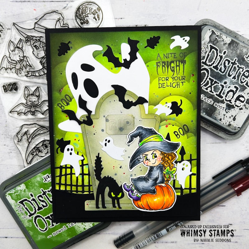 A handmade Halloween card featuring a green cloud background with black bats, white ghosts, a tombstone, a witch sitting on an orange pumpkin, and the text 'A Nite of Fright for Your Delight!'.