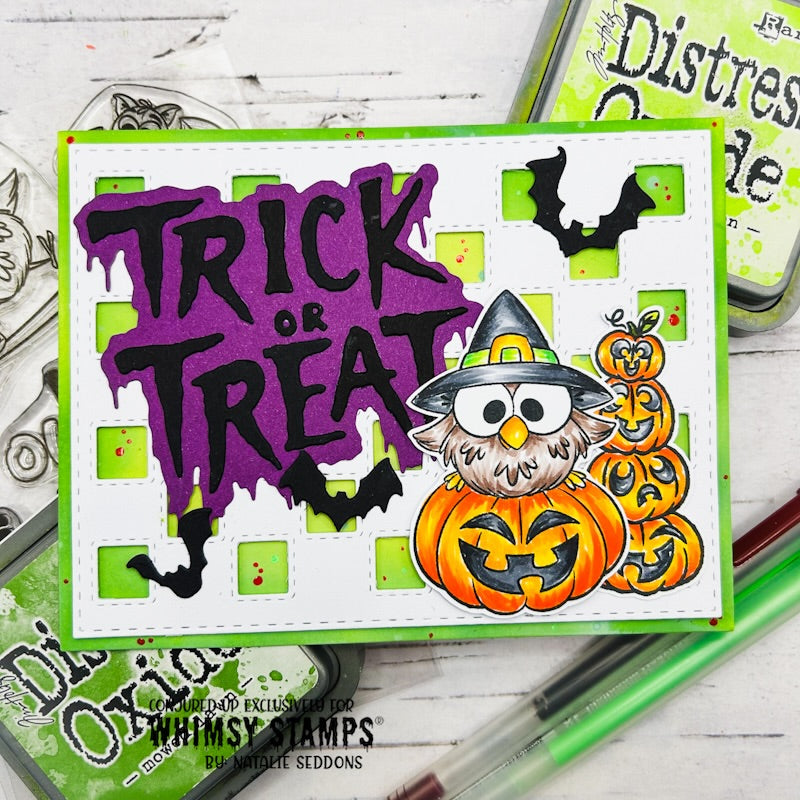 A handmade Halloween card featuring the words 'TRICK OR TREAT' in dripping purple lettering, black bats, a white-and-green checkered background, and a cartoon owl wearing a witch hat above jack-o'-lanterns.