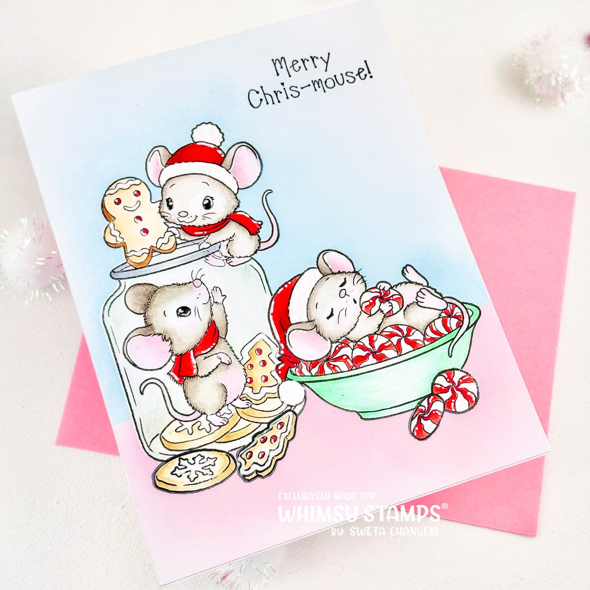 A festive greeting card featuring three cute illustrated mice in Christmas attire with candy canes and cookies. Finished with the sentiment Merry Chris-mouse!