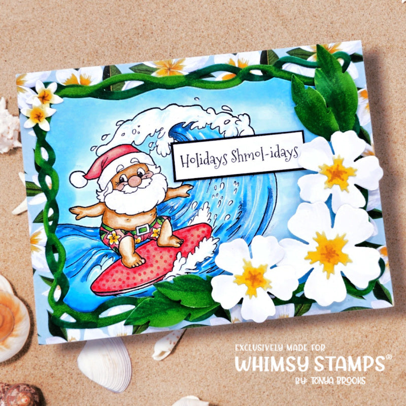 A handmade greeting card featuring a cartoon Santa Claus surfing on a red surfboard and large blue wave with white flowers and green leaves around the border. Finished with the sentiment 'Holidays Shmol-idays'.